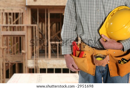 A repairman holding his helmet with a belt full of tools