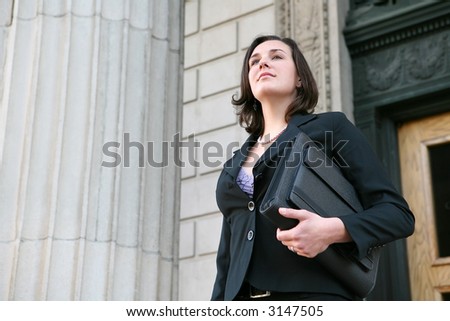 A young pretty business woman leaving the office building