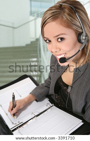 A pretty customer service woman taking notes