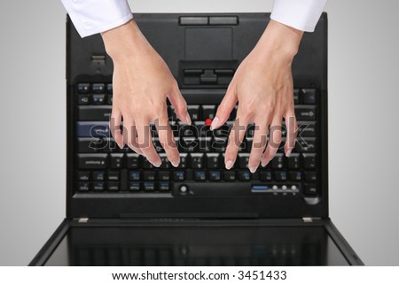 A woman typing on the laptop computer