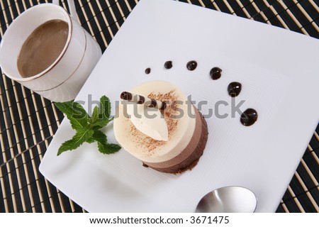 A chocolate mocha flavored cake tart dessert on a plate with coffee