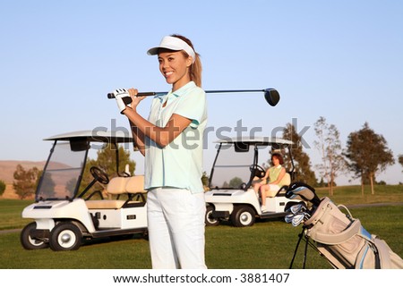 A pretty woman golfer ready to hit on the fairway