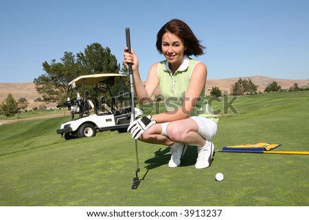 A pretty woman in the middle of a golf game