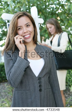 A beautiful young real estate agent woman on the phone