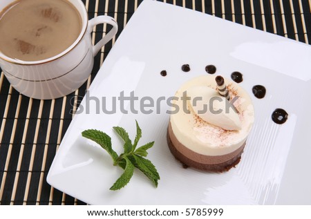 A chocolate mocha flavored cake tart dessert on a plate with coffee