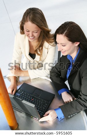 A pretty business team at an outside table on the computer
