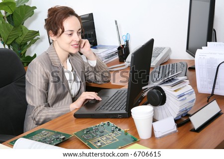 A pretty, busy business woman working on her laptop computer
