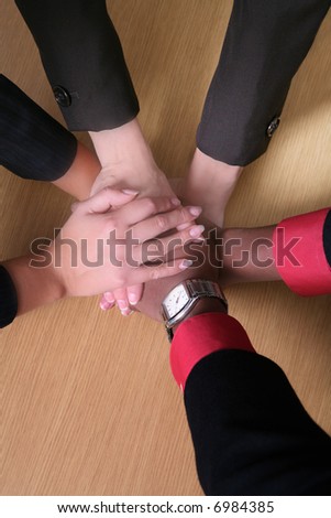 A group or team of business workers with their hands together