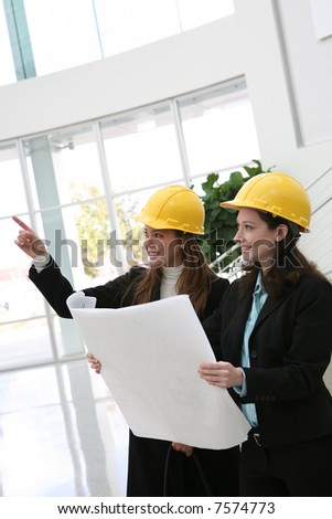 Pretty women architects inspecting the architecture at the work site