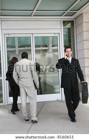 Business people entering and exiting the company