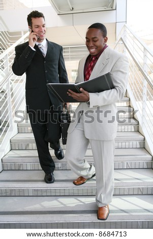 A diverse business man team walking down stairs
