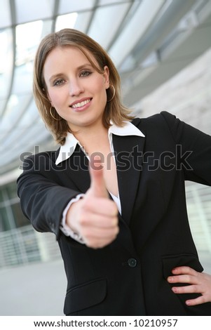 A pretty blonde business woman with her thumbs up