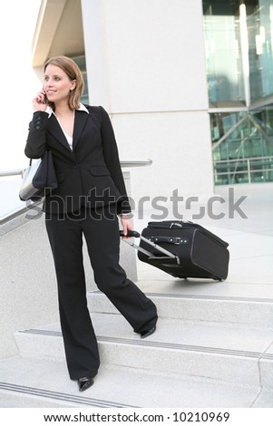 A pretty blonde business woman travelling with cell phone