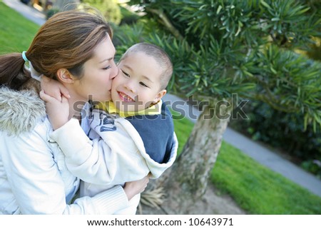 A mother kissing her son with love