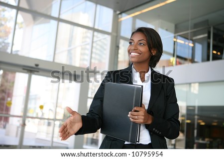 A pretty african american business woman offering a handshake