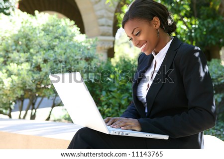A pretty african american business woman at college on computer
