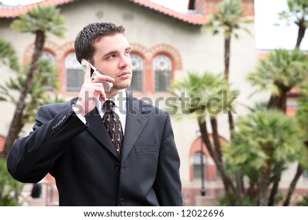 A handsome college professor man talking on the phone at university