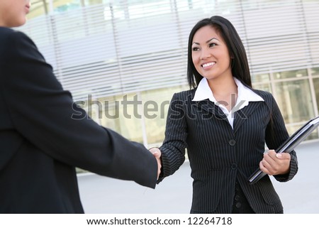 A beautiful young asian business woman shaking hands
