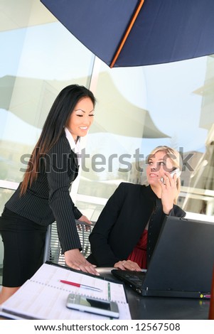Attractive, young, diverse business woman team working on a project