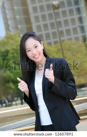 A pretty asian woman celebrating a success at work