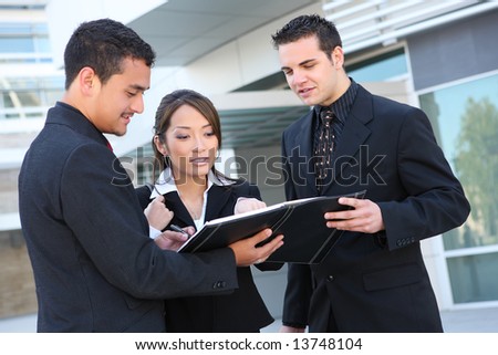 An attractive, diverse business team at office building