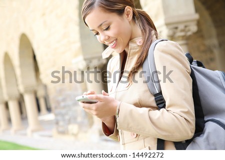 A pretty young woman on the cell phone on the school campus
