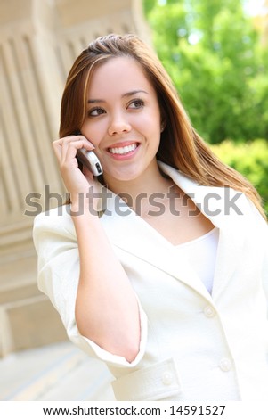 A pretty young woman on the cell phone on the school campus