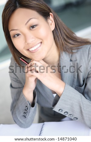 http://image.shutterstock.com/display_pic_with_logo/4884/4884,1215987048,5/stock-photo-a-young-pretty-asian-business-woman-at-work-14871040.jpg