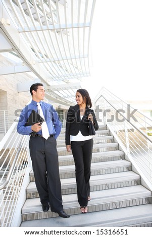 A diverse man and woman business team at their company office building