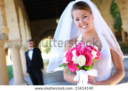 stock photo A beautiful bride with groom in background at church wedding