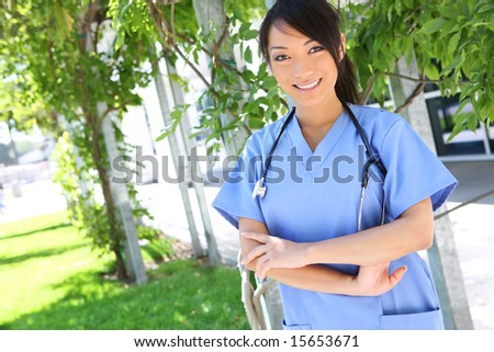 A young pretty asian nurse outside the hospital