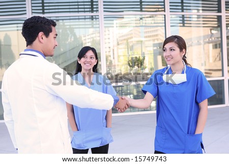 A successful medical team meeting outside hospital building