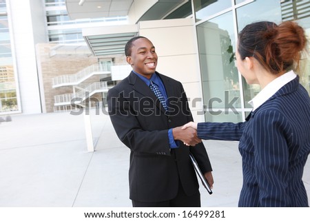 An attractive team of diverse business people shaking hands