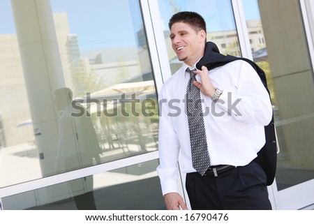 A handsome business man outside office building leaving for the day