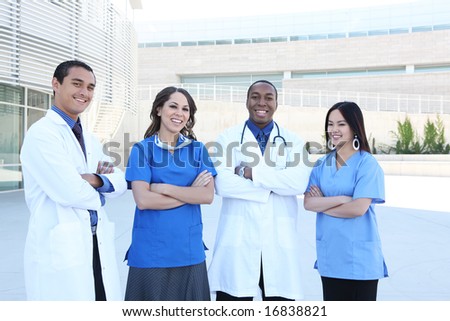 A happy and successful medical team outside hospital building