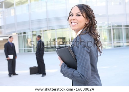 A young, pretty business woman outside an office building