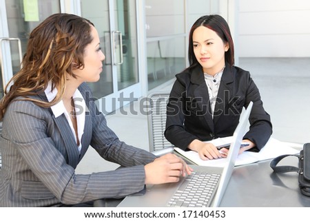An attractive, diverse business team meeting as a group at office