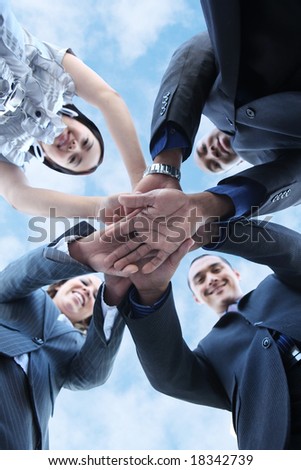 A diverse business man and woman team with hands together