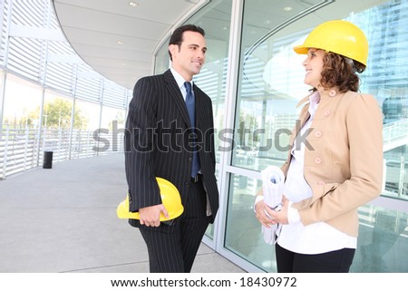 Man and woman architects on a building construction site