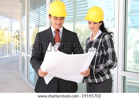 Man and woman architects on building construction site working