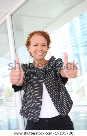 A pretty african american business woman outside office building