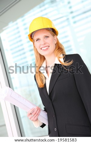 A pretty young woman architect on building construction site