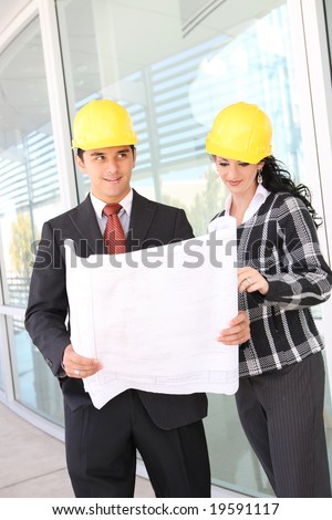 Man and woman architects on building construction site working