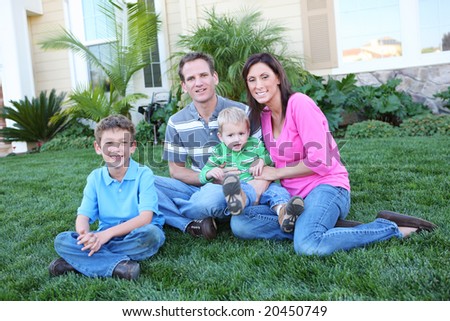 A happy family having fun outdoors in front of their home