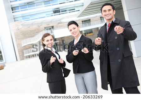 A young and diverse man and woman business team at office pointing