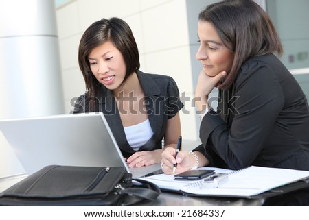 An attractive business team meeting at office on laptop computer