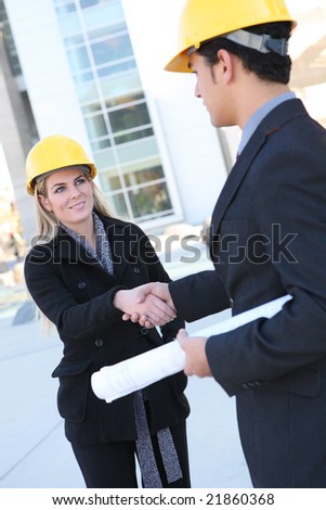 An attractive business construction team shaking hands on the building site