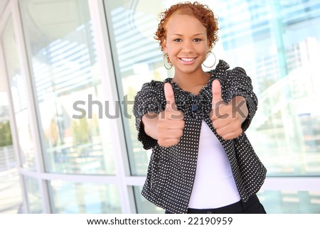 A sexy african american business woman with thumbs up
