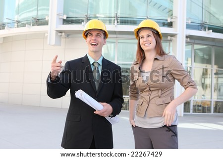 Attractive Man and woman team on a building construction site