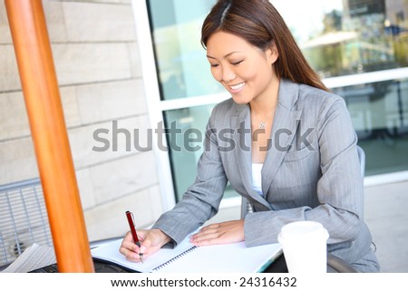 A young, pretty asian business woman at work